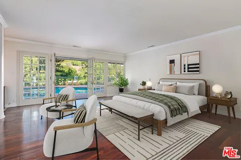 a spacious bathroom with a tub sink and mirror