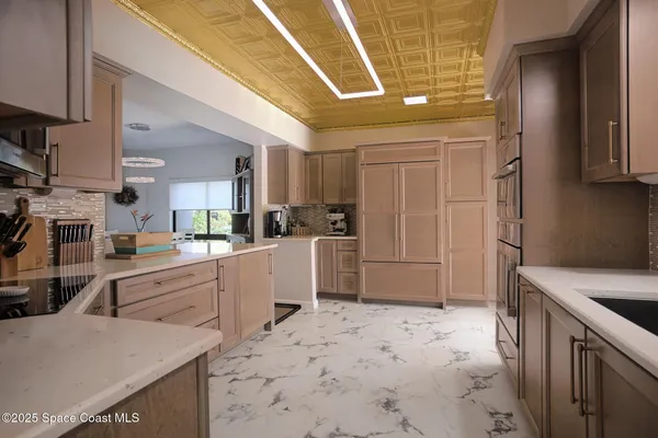 a kitchen with a sink refrigerator and cabinets