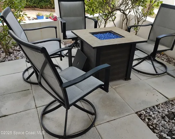 a backyard with plants and outdoor seating