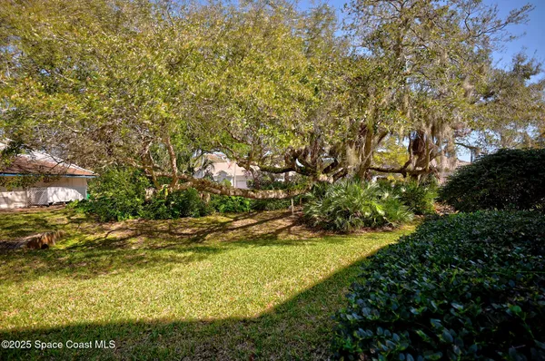 a view of a lake with boats and trees in the background