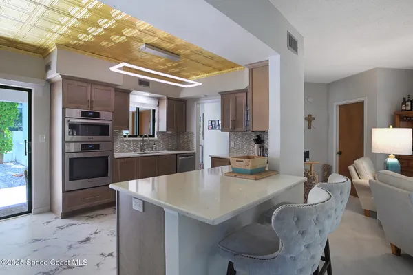 a kitchen with granite countertop stainless steel appliances and wooden cabinets