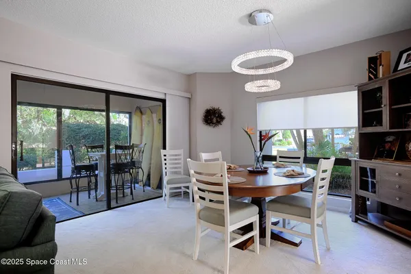 a dining room with furniture and a large window