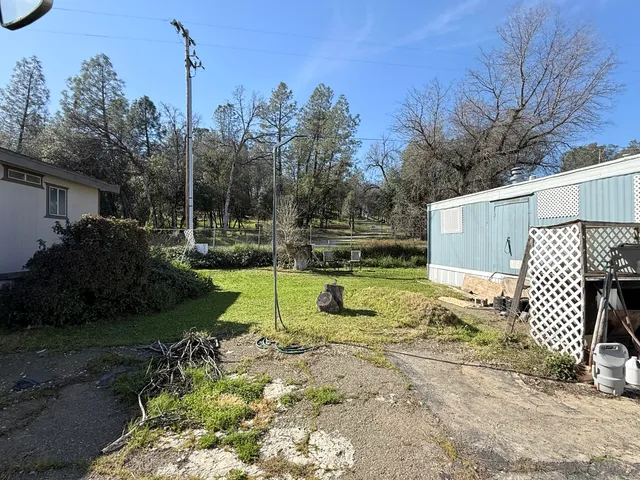 a view of a backyard with sitting area