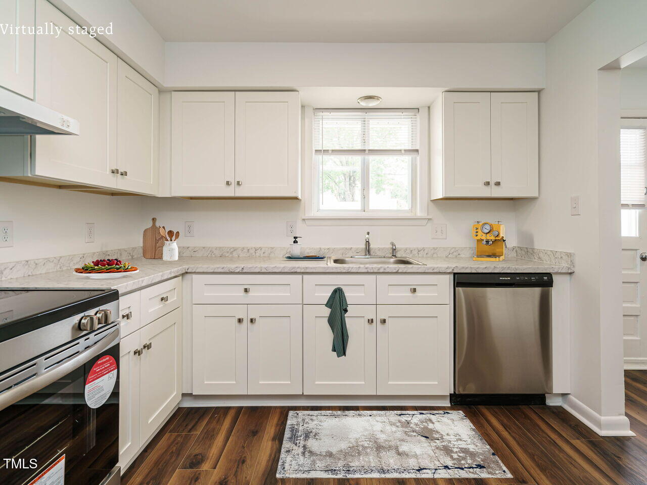 2316 Champion Court Raleigh, NC 27606 - Photo 15 of 27 a kitchen with stainless steel appliances granite countertop a sink stove and cabinets