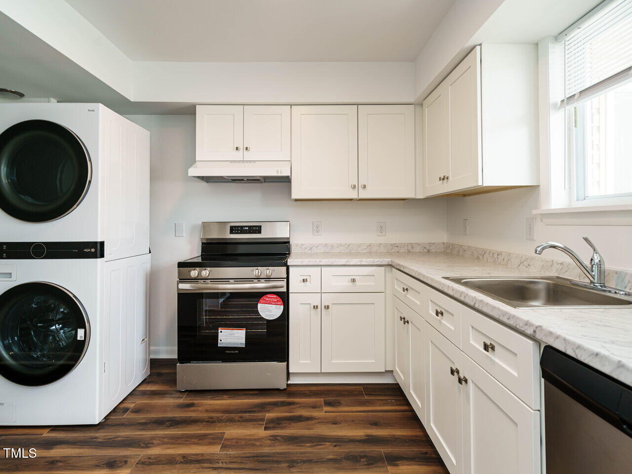 2316 Champion Court Raleigh, NC 27606 - Photo 16 of 27 a kitchen with granite countertop a stove top oven and cabinets