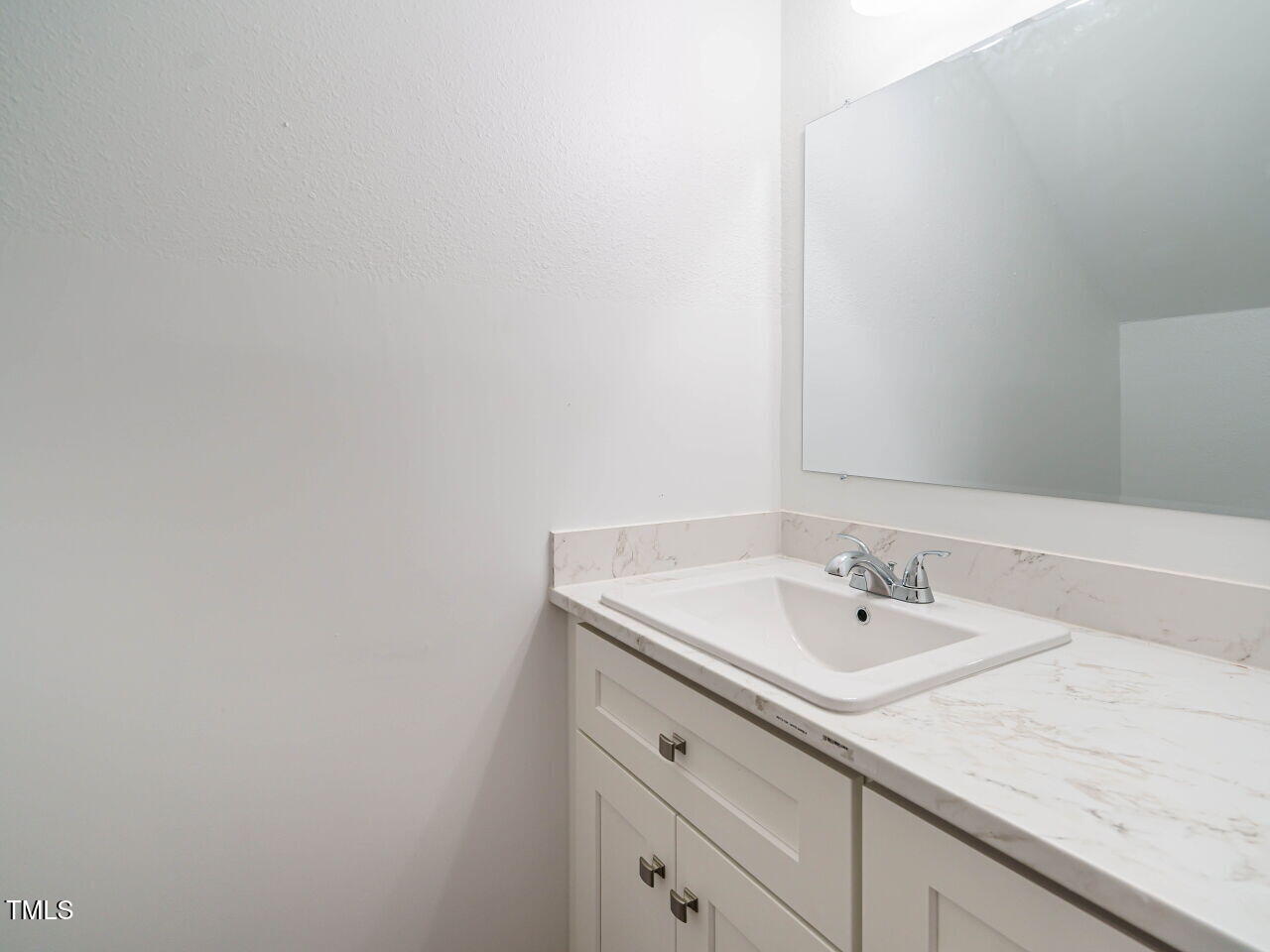 2316 Champion Court Raleigh, NC 27606 - Photo 17 of 27 a bathroom with a sink and a mirror
