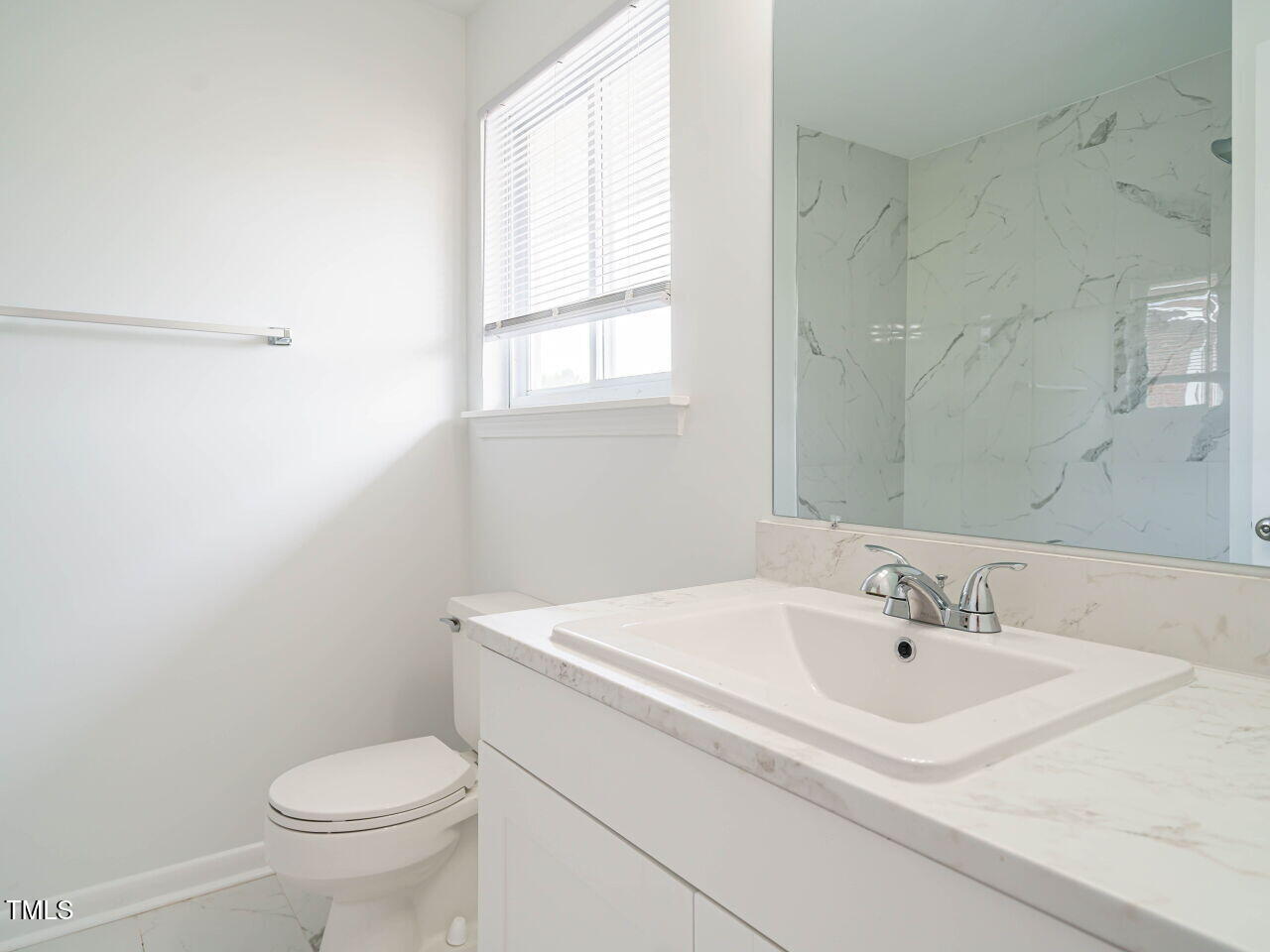 2316 Champion Court Raleigh, NC 27606 - Photo 20 of 27 a bathroom with a sink toilet and a window