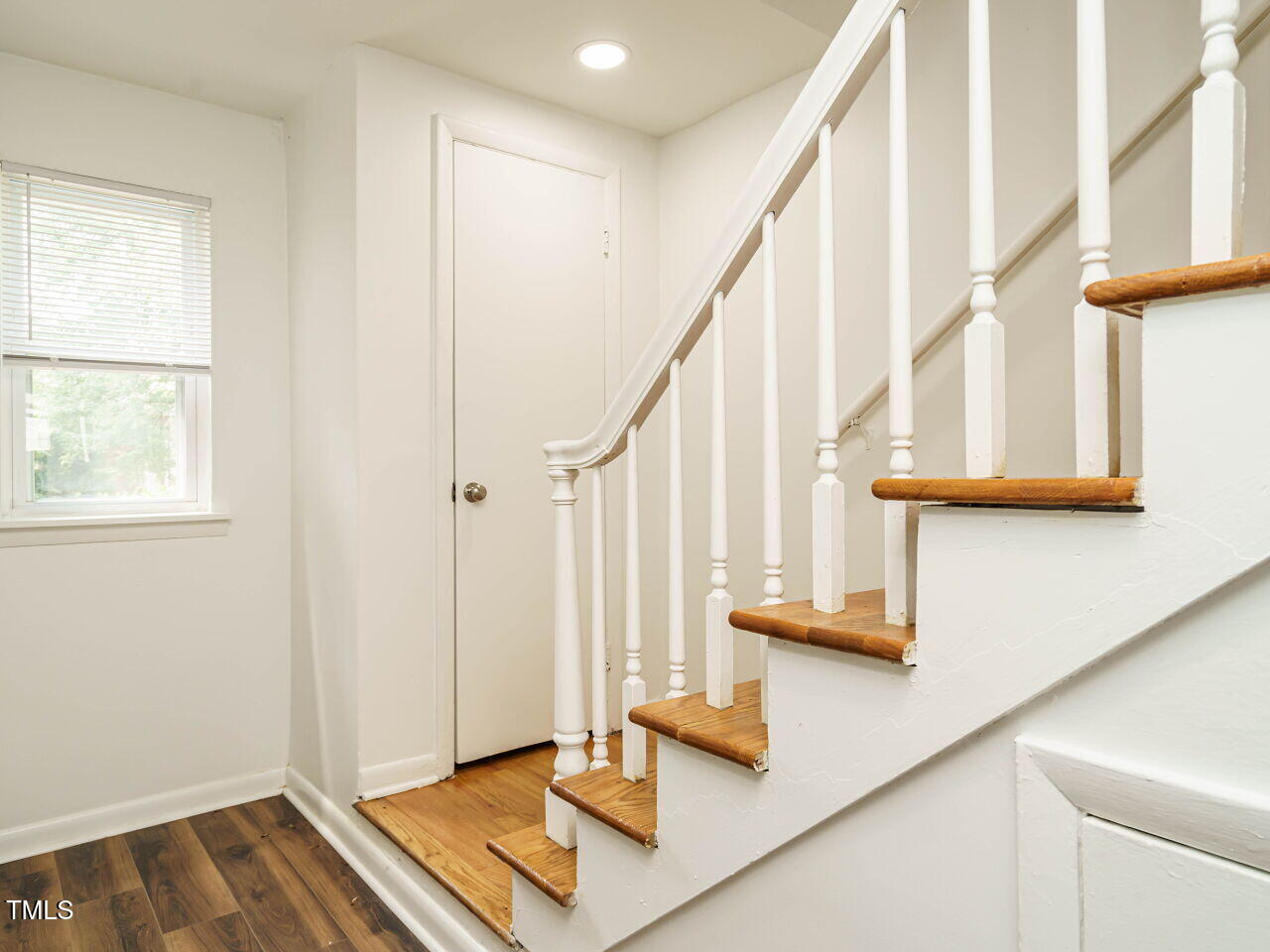 2316 Champion Court Raleigh, NC 27606 - Photo 4 of 27 a view of staircase with white walls and a window