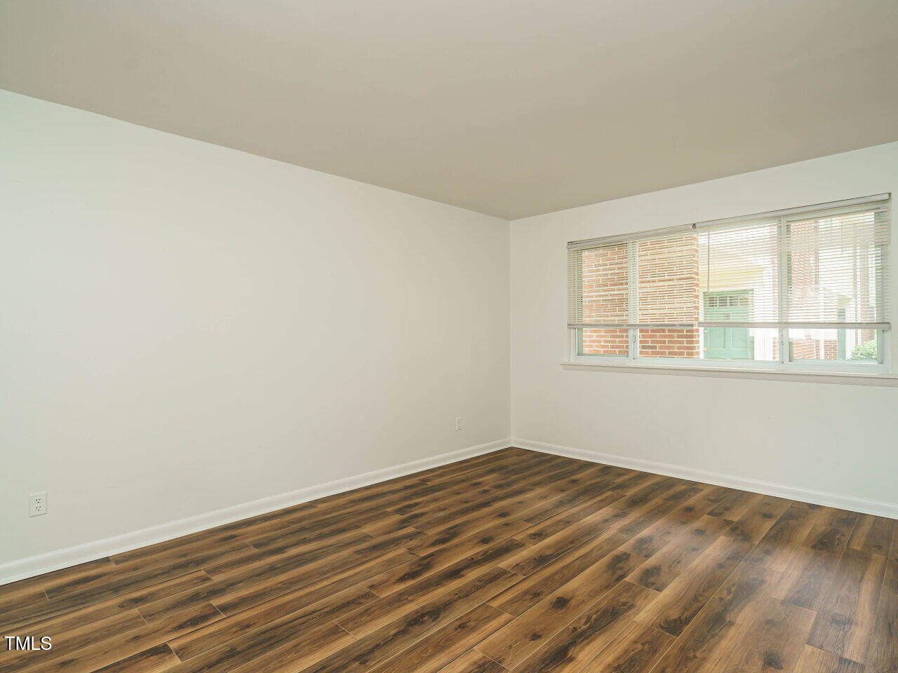 2316 Champion Court Raleigh, NC 27606 - Photo 8 of 27 a view of empty room with wooden floor and fan