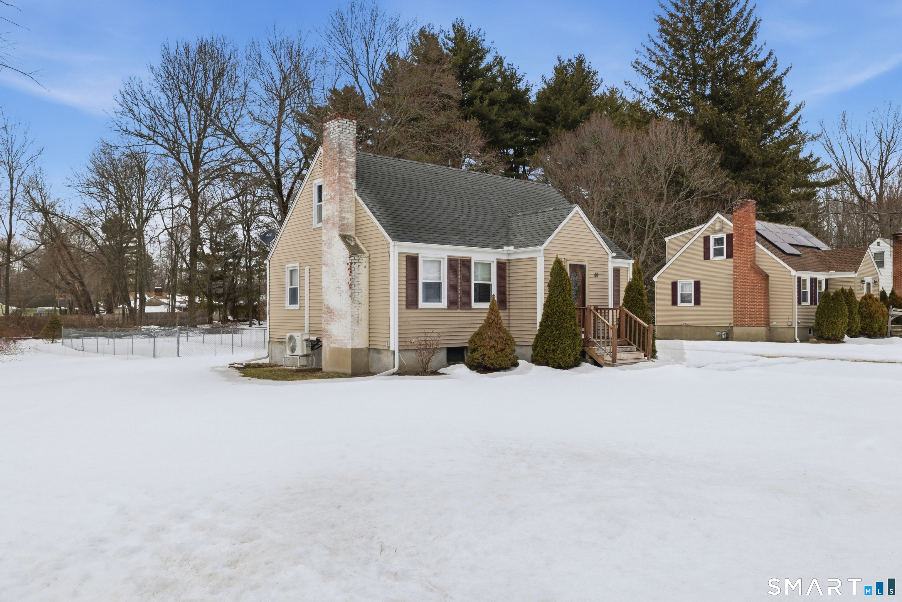 49 Tyler Street Bloomfield, CT 06002 - Photo 1 of 38 a view of a white house with a yard covered in snow
