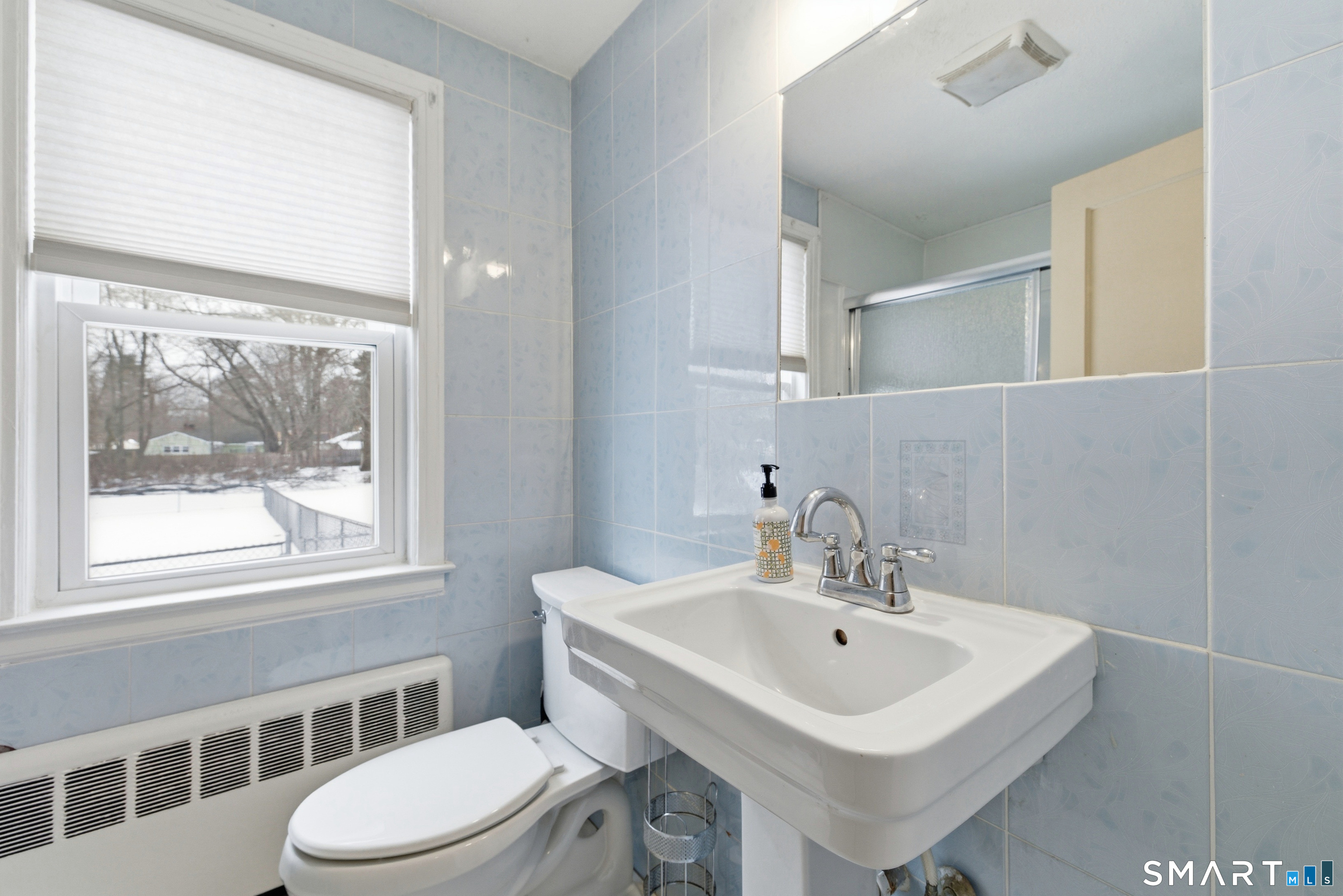 49 Tyler Street Bloomfield, CT 06002 - Photo 14 of 38 a white sink sitting next to a white toilet