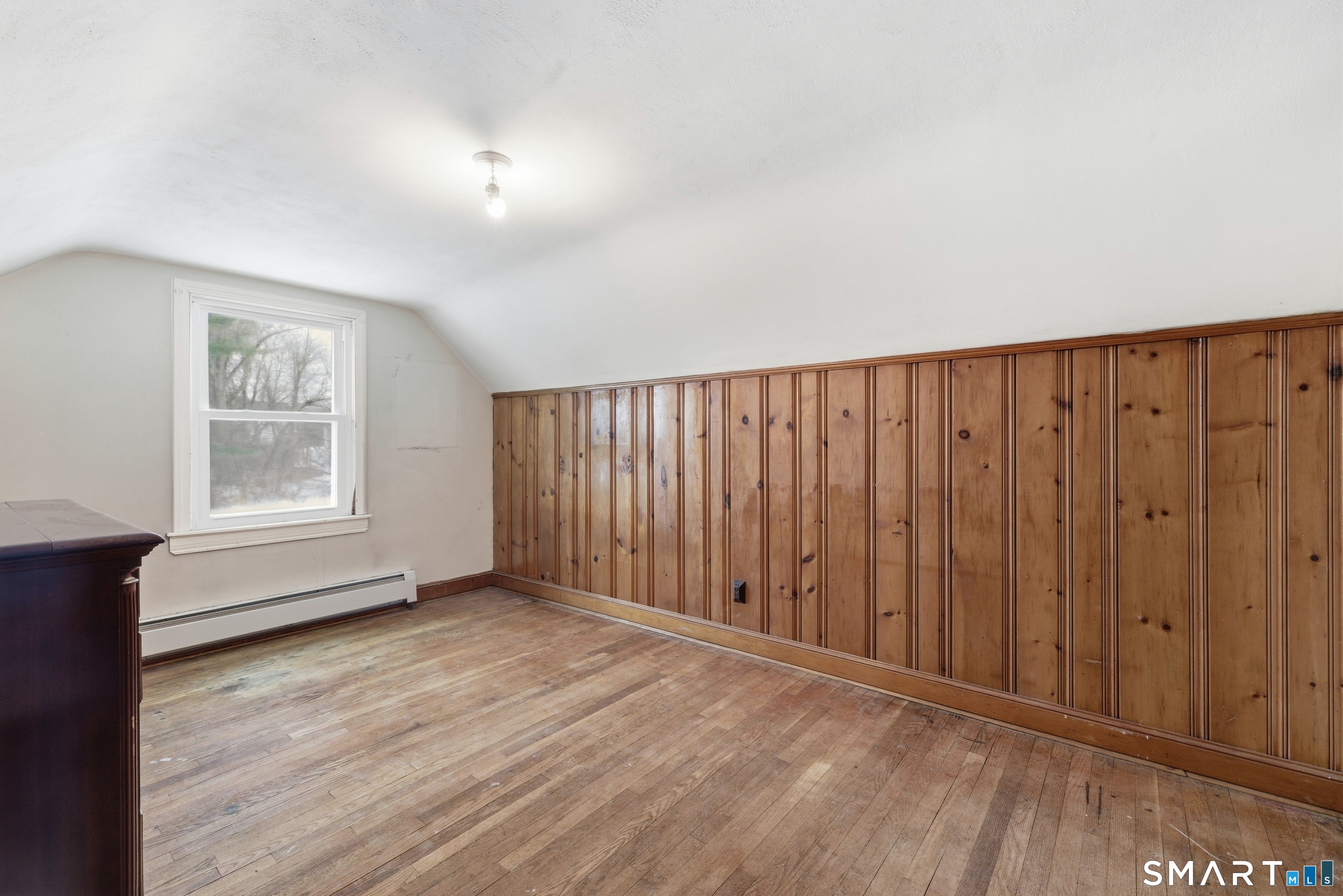 49 Tyler Street Bloomfield, CT 06002 - Photo 18 of 38 a view of an empty room with wooden floor and a window