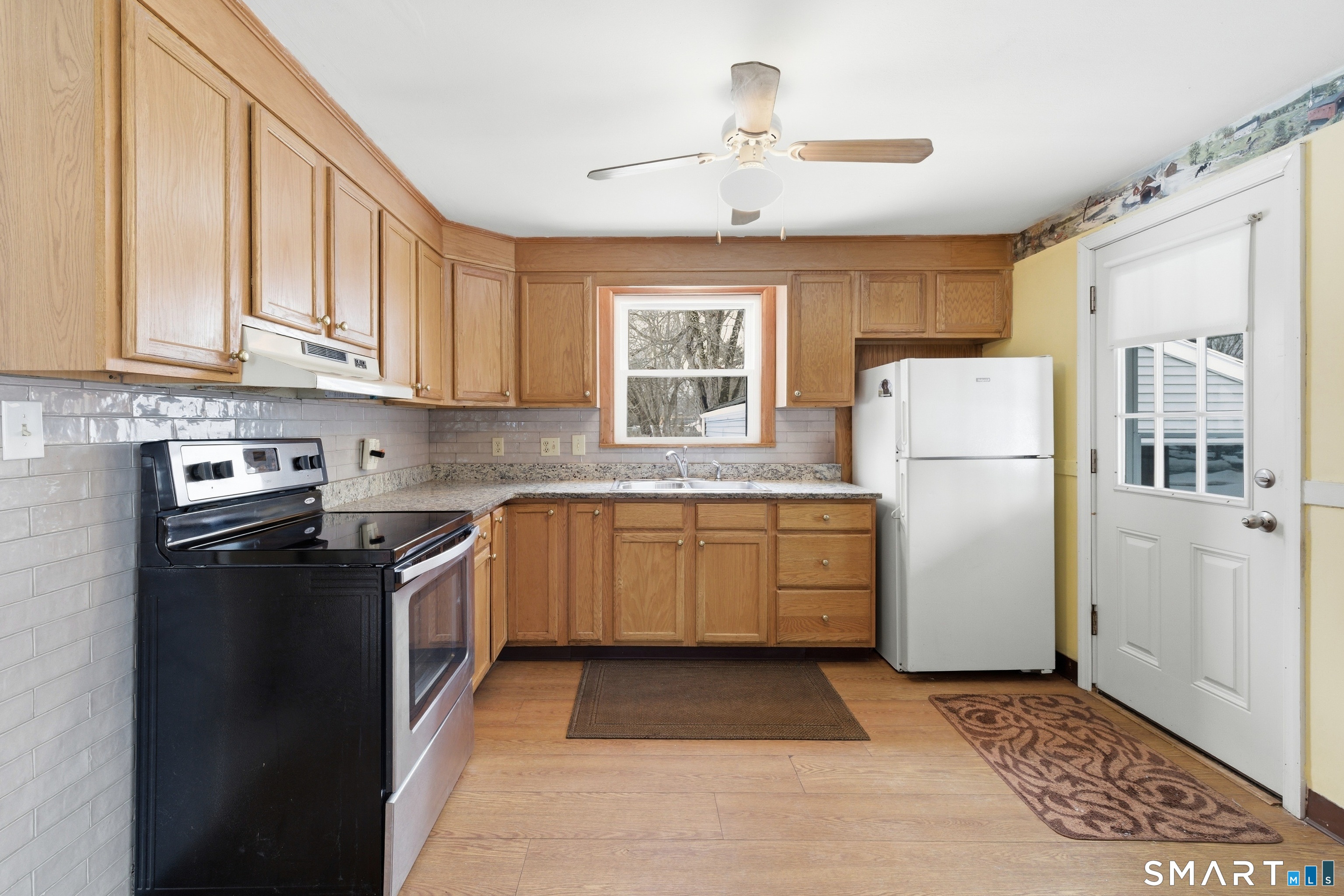 49 Tyler Street Bloomfield, CT 06002 - Photo 20 of 38 a kitchen with a refrigerator and a stove top oven