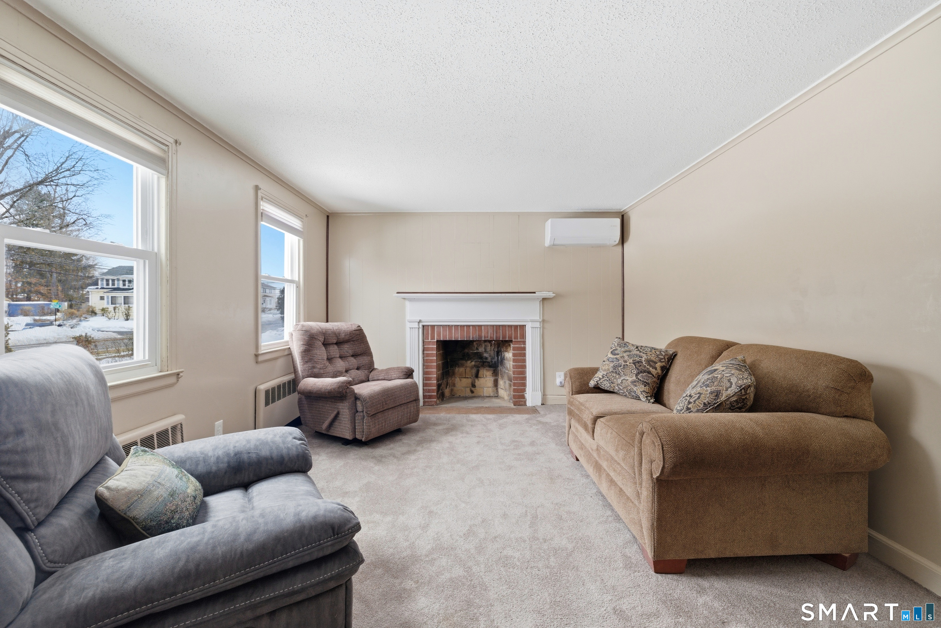 49 Tyler Street Bloomfield, CT 06002 - Photo 3 of 38 a living room with furniture and a fireplace