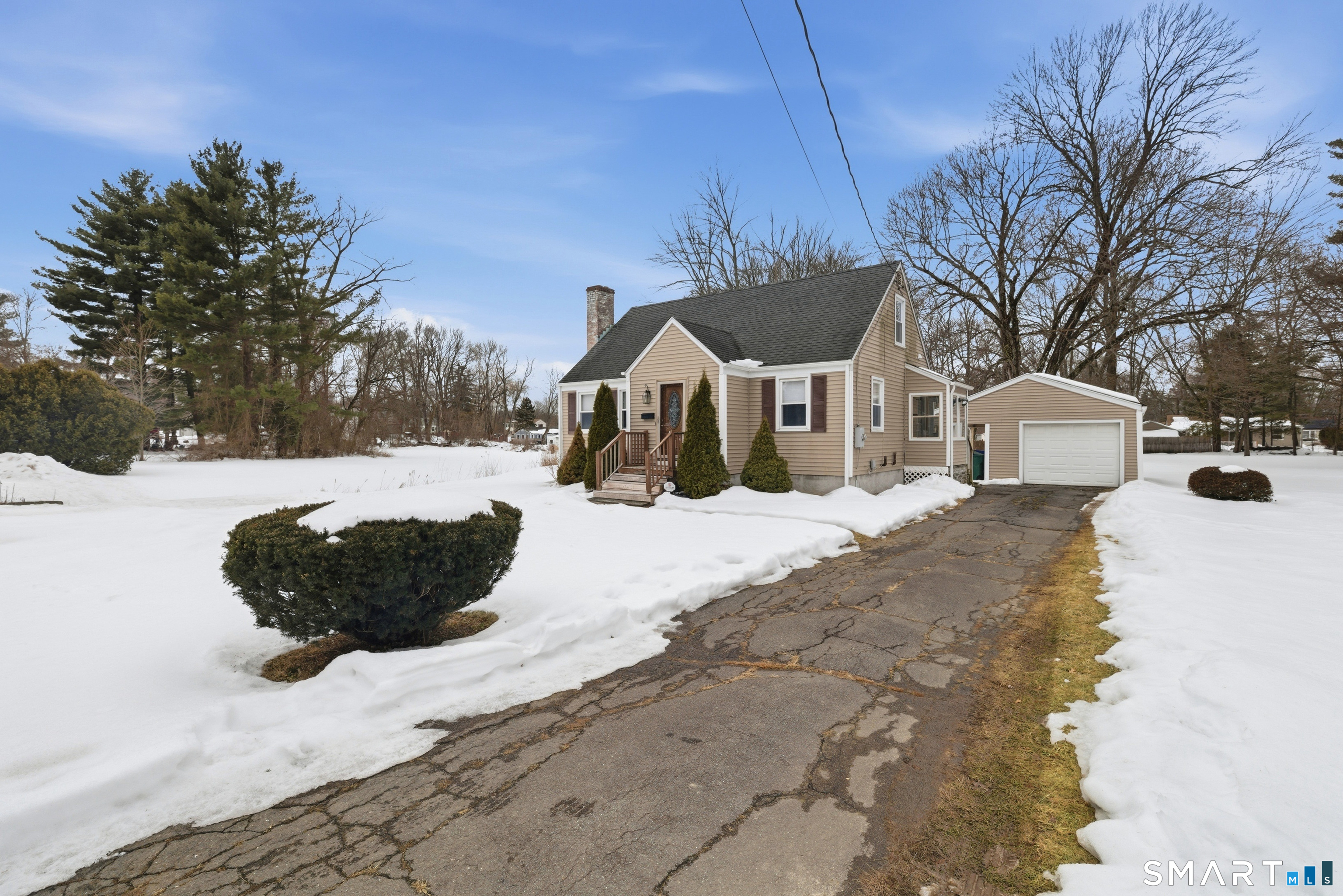 49 Tyler Street Bloomfield, CT 06002 - Photo 5 of 38 a view of a house with a yard covered in snow