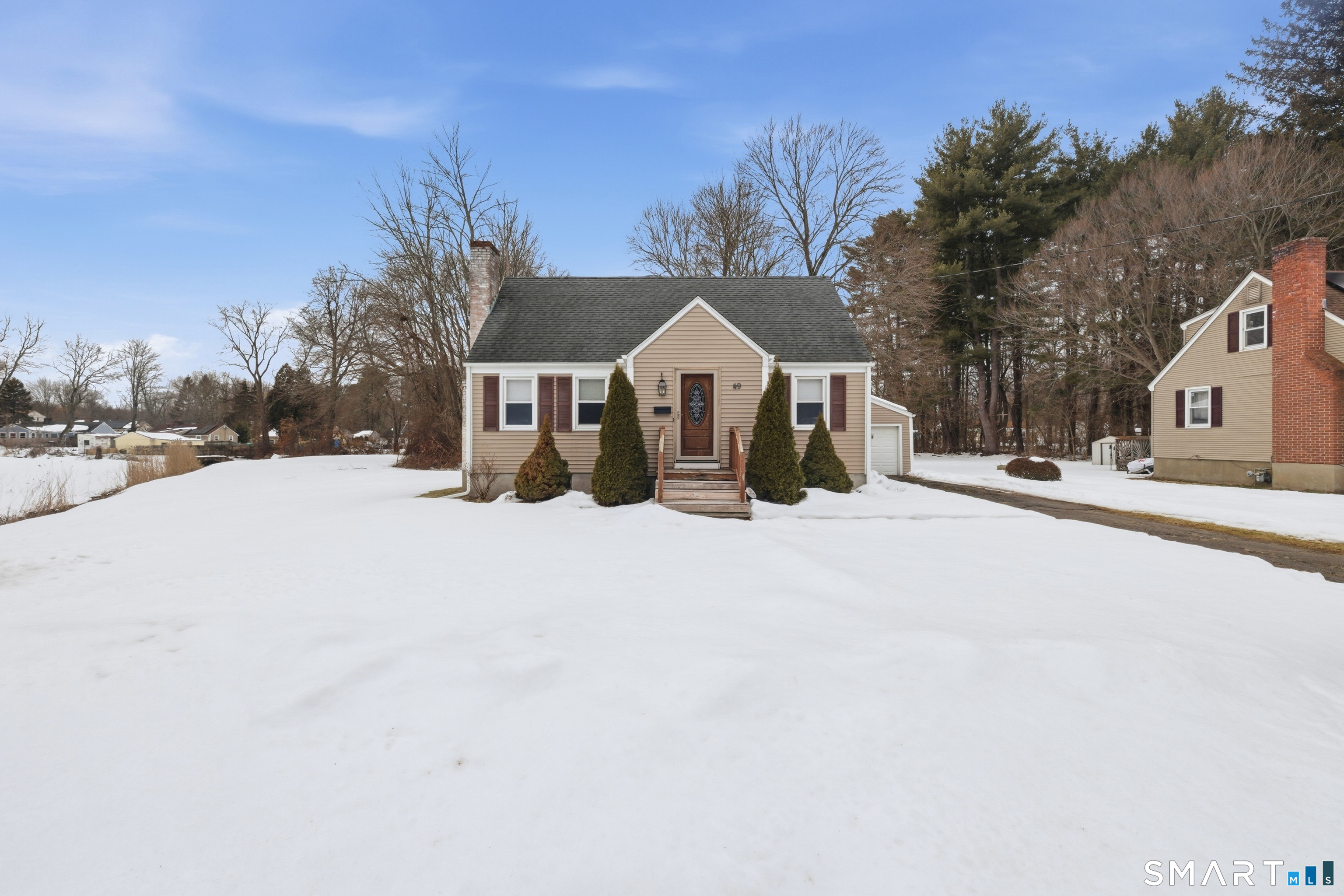 49 Tyler Street Bloomfield, CT 06002 - Photo 7 of 38 a view of a house with a yard covered in snow
