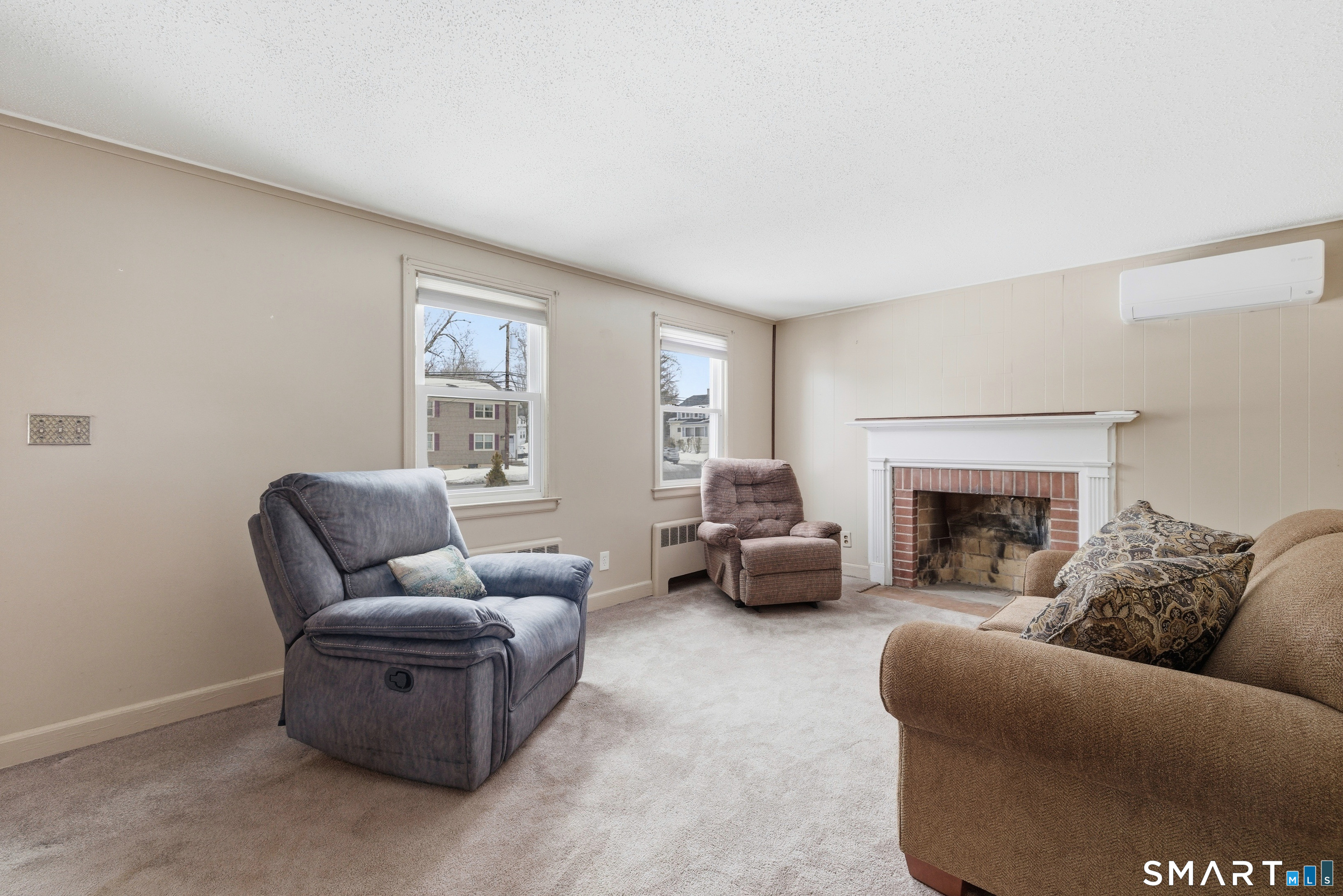49 Tyler Street Bloomfield, CT 06002 - Photo 8 of 38 a living room with furniture and a fireplace