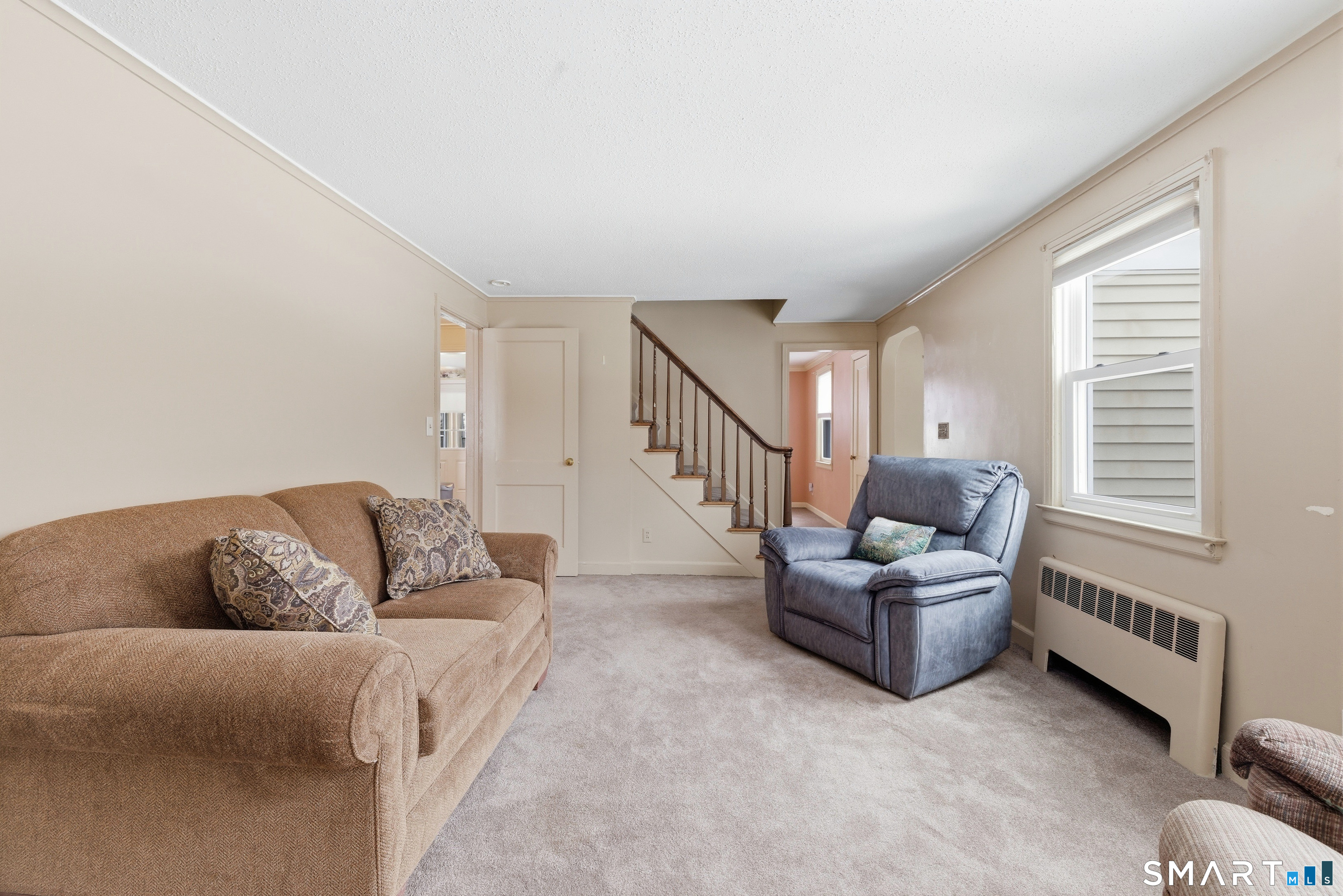 49 Tyler Street Bloomfield, CT 06002 - Photo 9 of 38 a living room with furniture and stairs