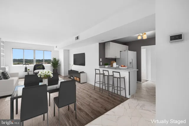 a living room with lots of furniture and a wooden floor