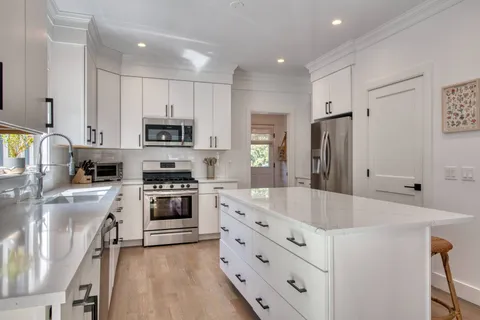 a kitchen with stainless steel appliances a refrigerator stove microwave and sink