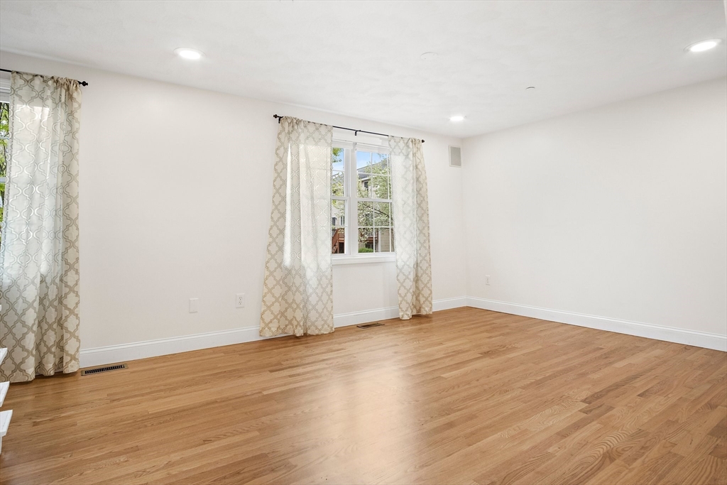 81 Salem Road, Unit 21 Billerica, MA 01821 - Photo 11 of 21 a view of an empty room with wooden floor and a window
