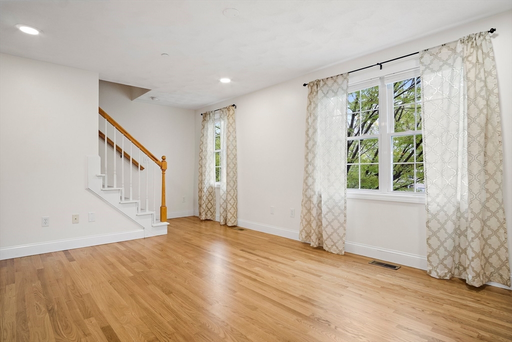 81 Salem Road, Unit 21 Billerica, MA 01821 - Photo 12 of 21 a view of an empty room with wooden floor and a window