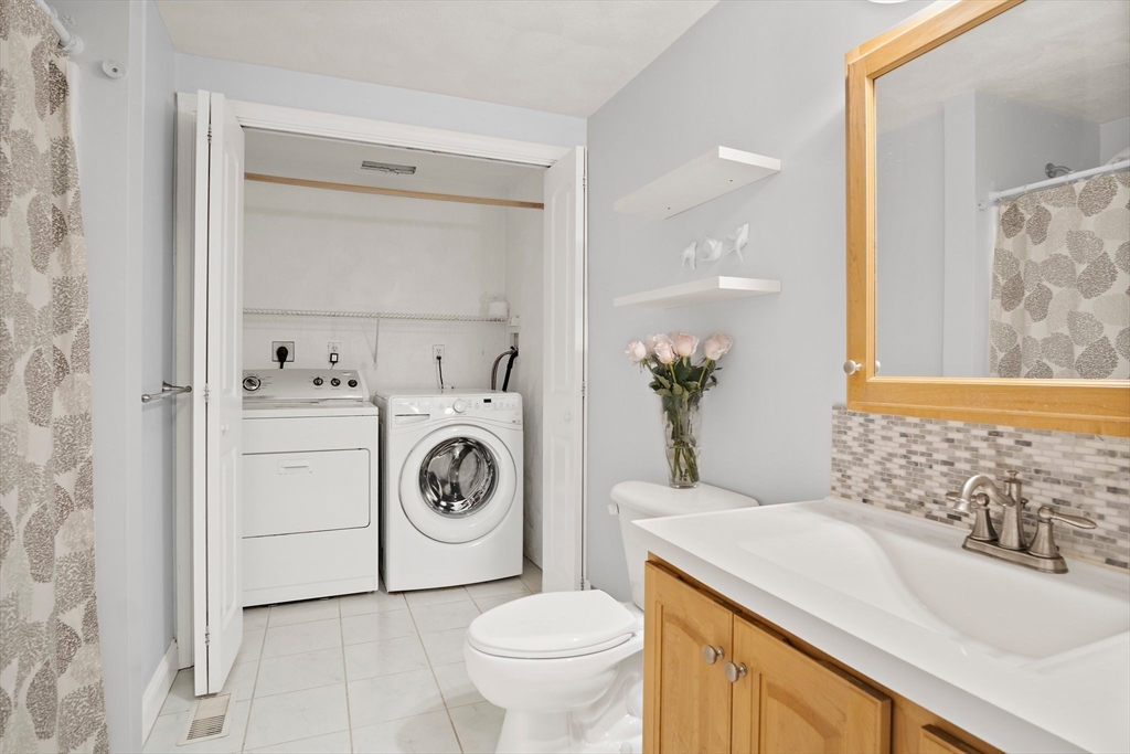 81 Salem Road, Unit 21 Billerica, MA 01821 - Photo 17 of 21 a bathroom with a sink a toilet and a mirror