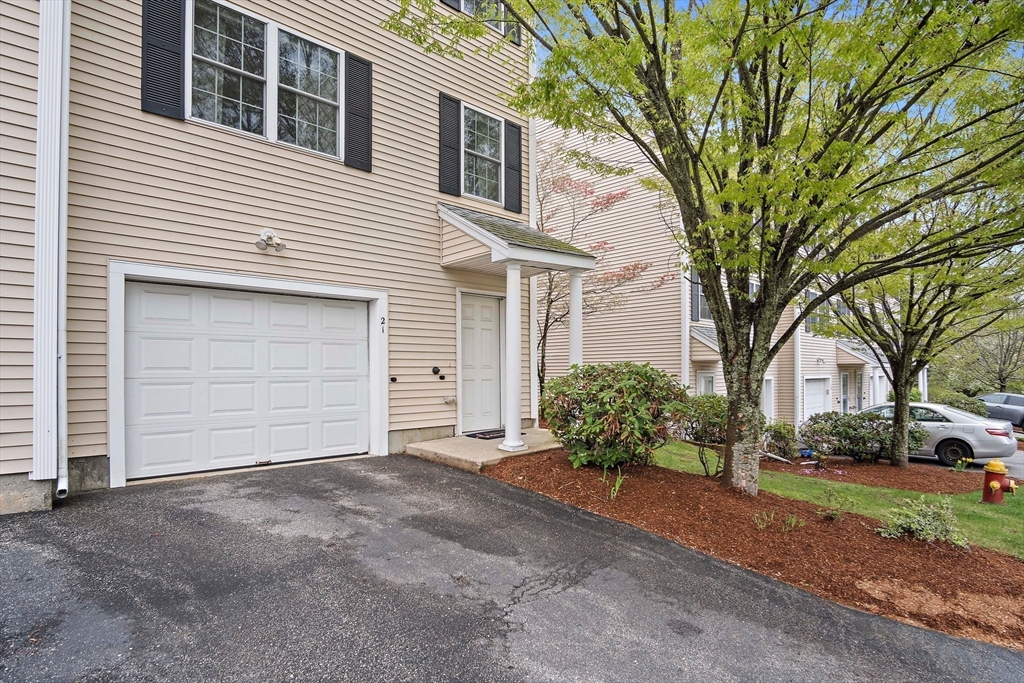 81 Salem Road, Unit 21 Billerica, MA 01821 - Photo 2 of 21 a view of a house with a yard and garage