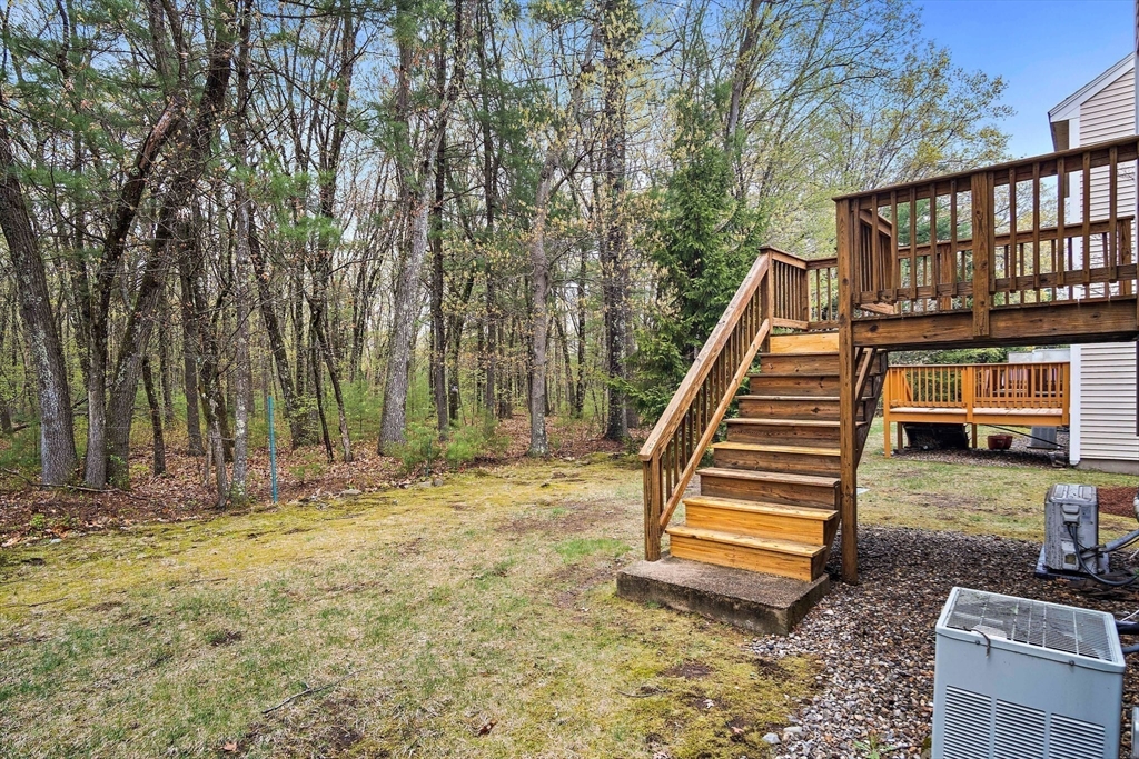 81 Salem Road, Unit 21 Billerica, MA 01821 - Photo 8 of 21 a backyard of a house with barbeque oven table and chairs