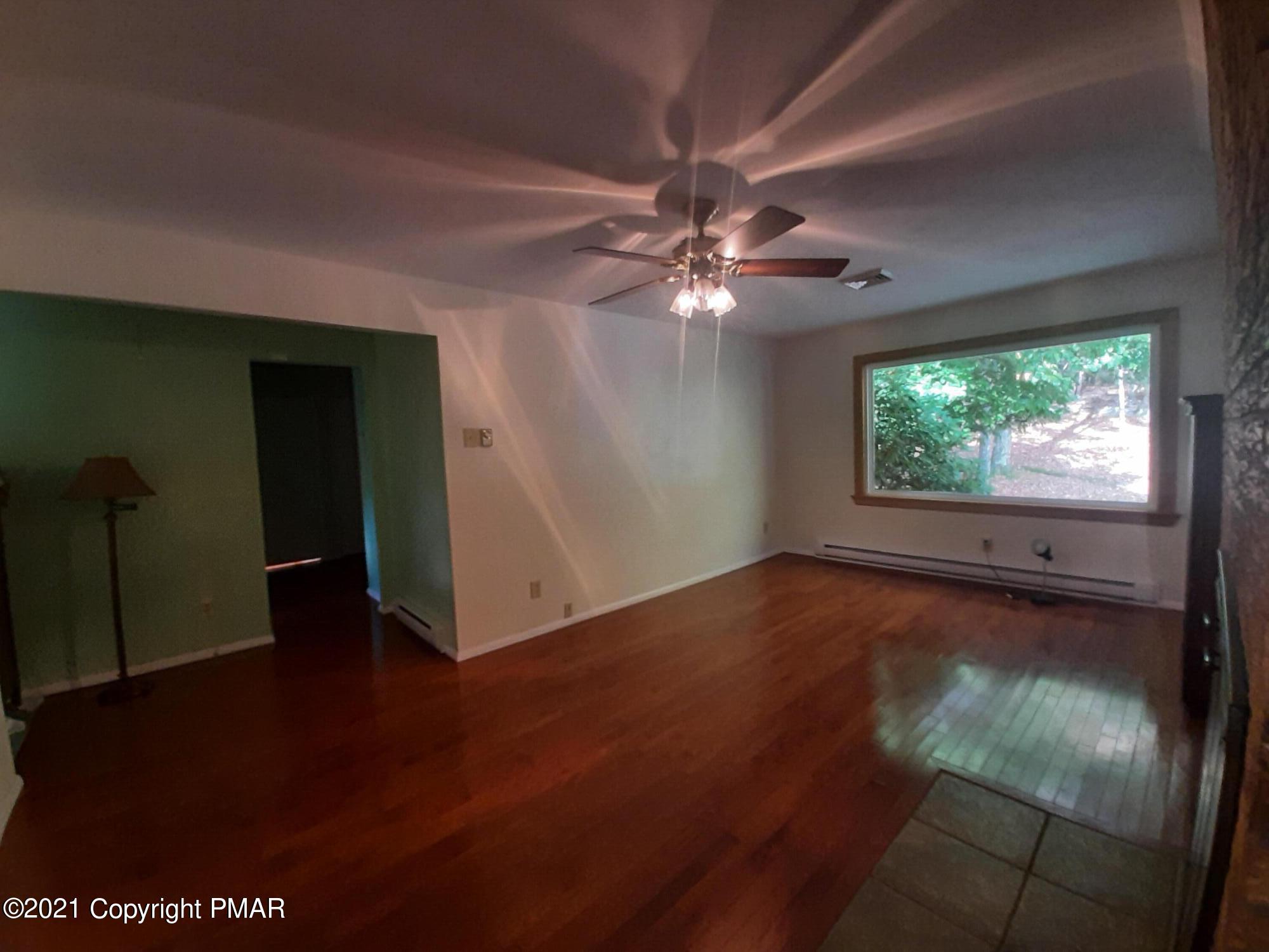 235 Dyson Road Swiftwater, PA 18370 - Photo 17 of 36 an empty room with wooden floor fan and window