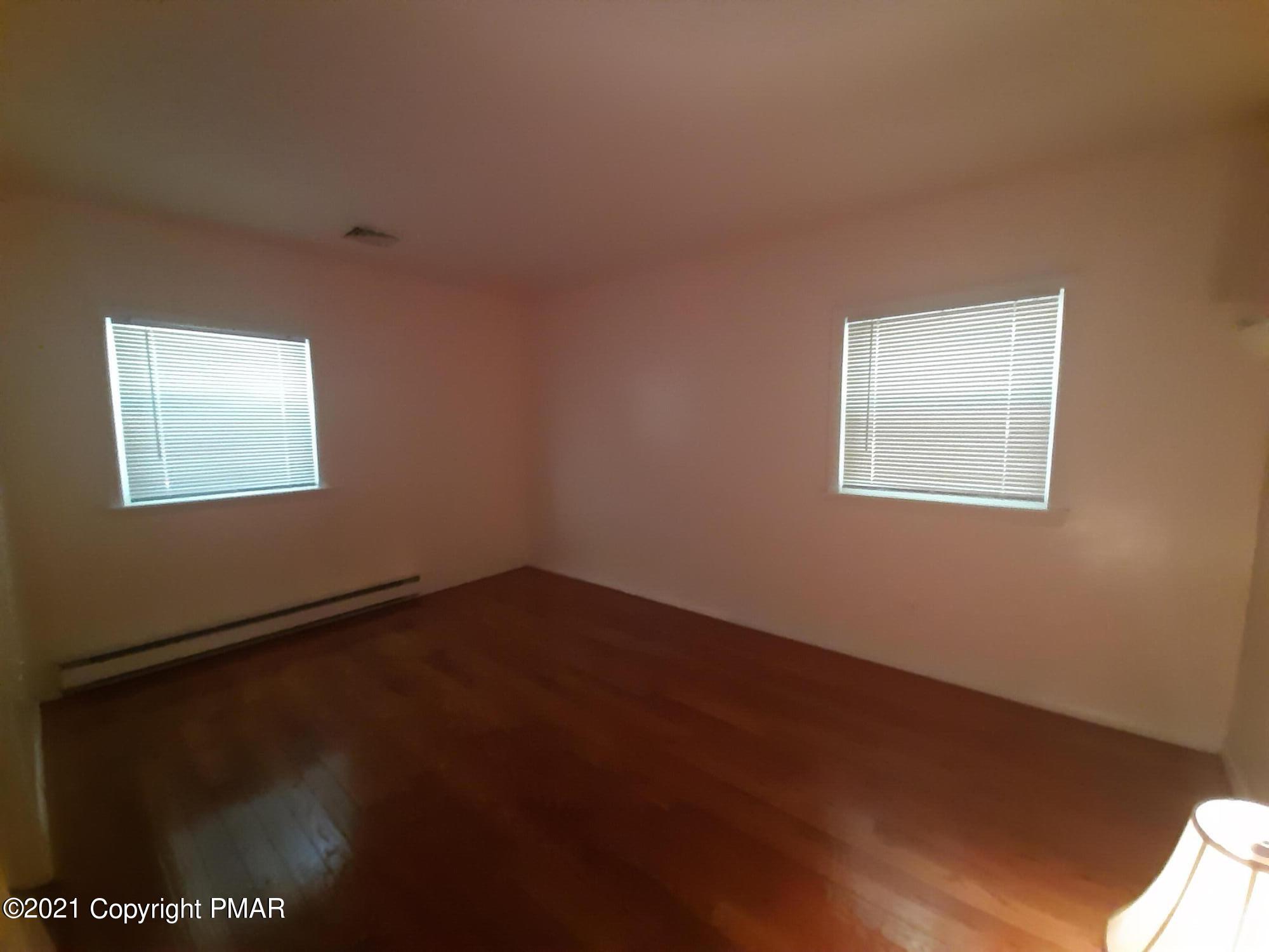 235 Dyson Road Swiftwater, PA 18370 - Photo 21 of 36 a view of an empty room with a window and wooden floor