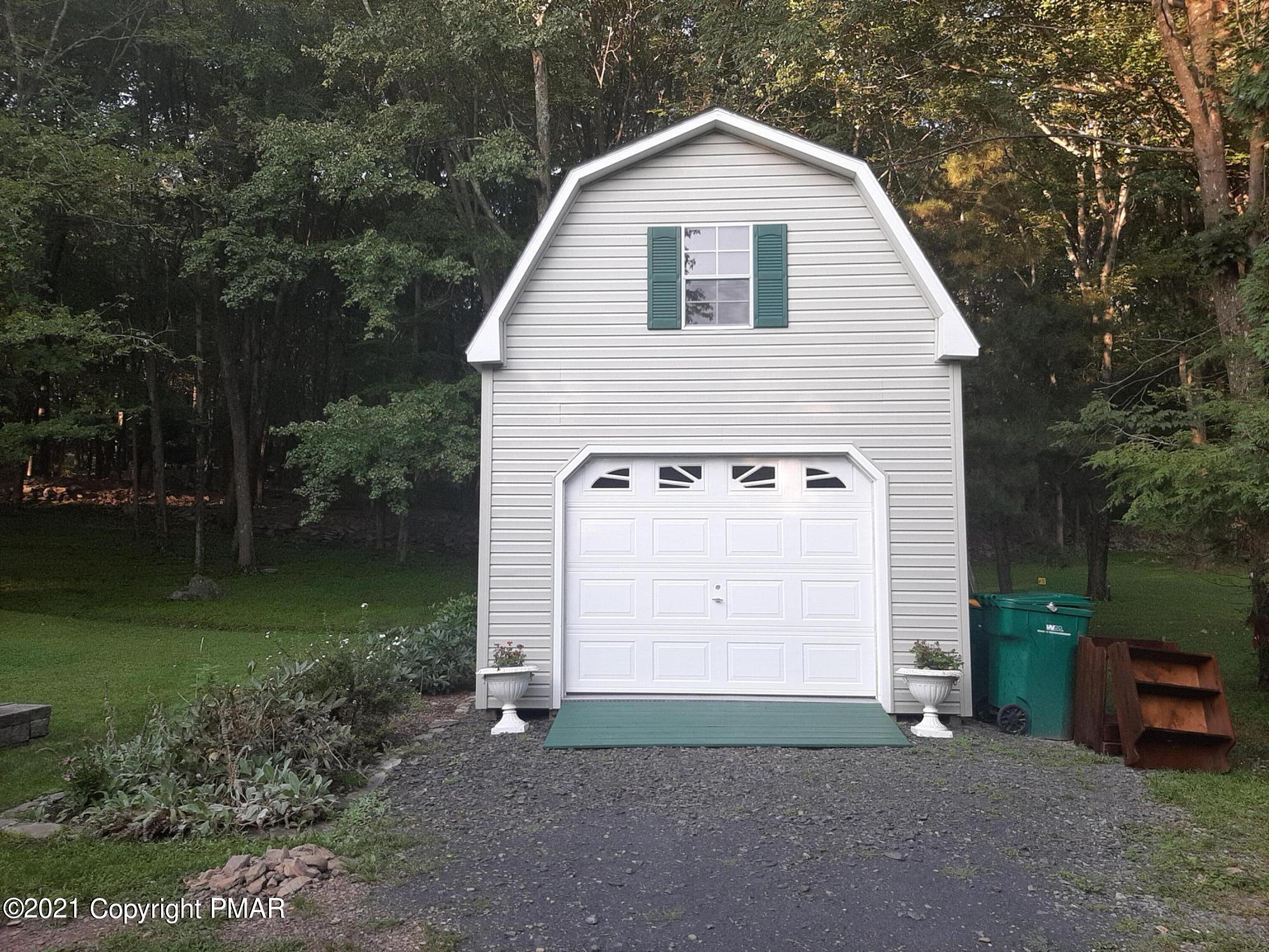 235 Dyson Road Swiftwater, PA 18370 - Photo 33 of 36 a view of a house with a yard and garage