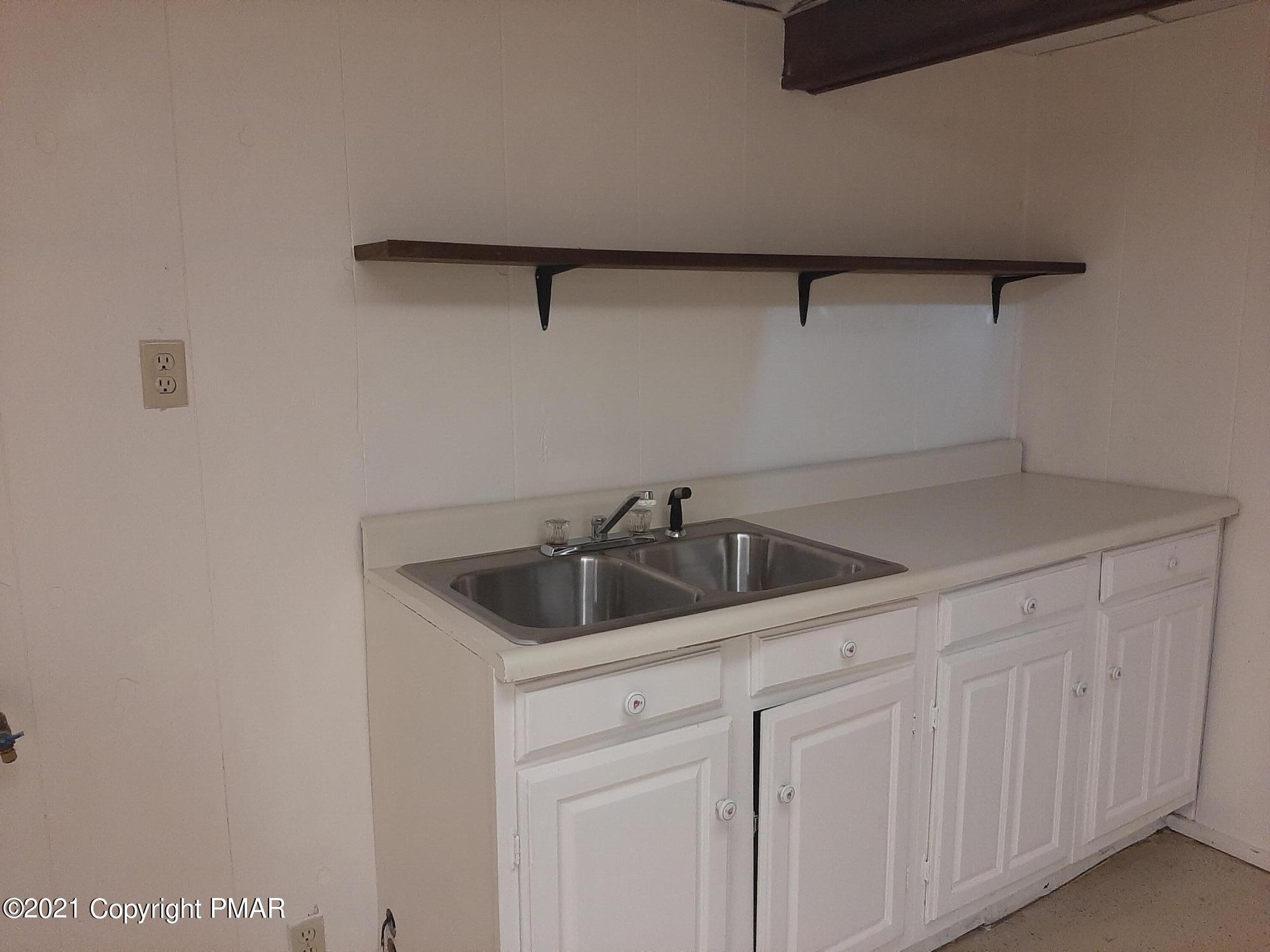 235 Dyson Road Swiftwater, PA 18370 - Photo 35 of 36 a kitchen with a sink and cabinets