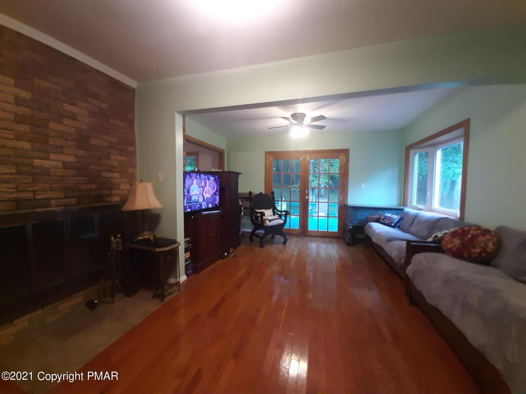 235 Dyson Road Swiftwater, PA 18370 - Photo 6 of 36 a living room with furniture and a flat screen tv