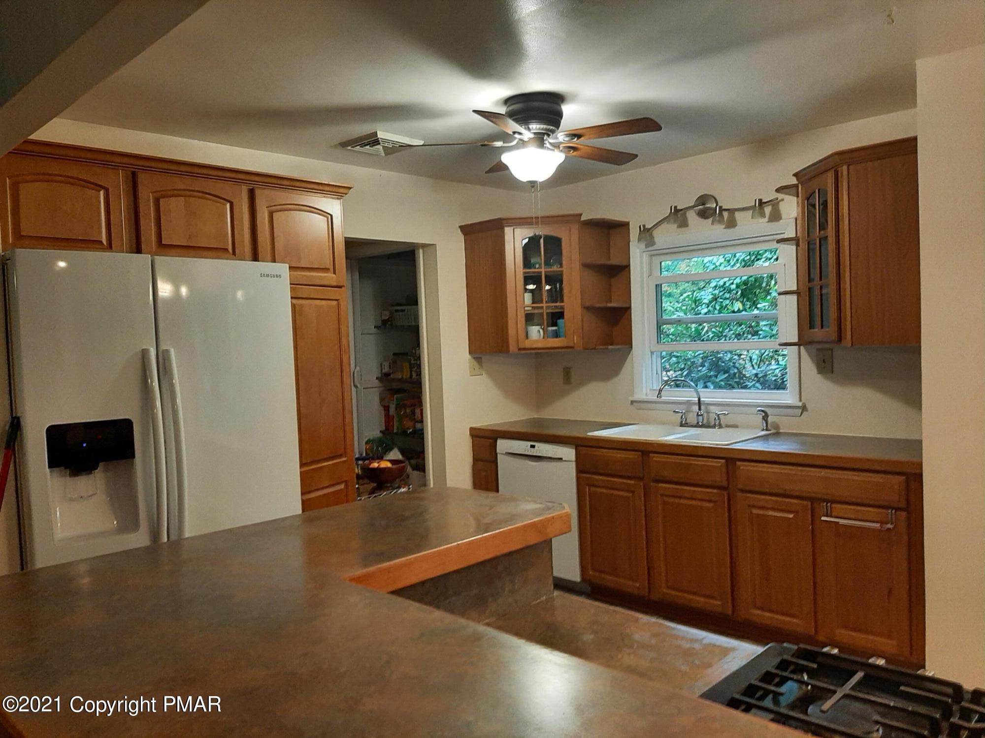 235 Dyson Road Swiftwater, PA 18370 - Photo 10 of 36 a kitchen with stainless steel appliances a sink stove and refrigerator