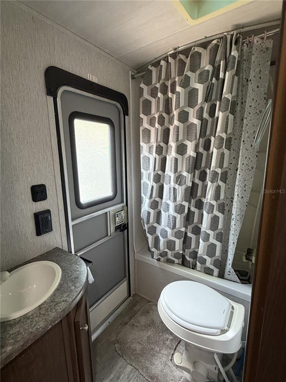 3000 Clarcona Road, Unit 743 Apopka, FL 32703 - Photo 44 of 54 a bathroom with a granite countertop toilet sink and mirror