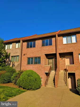 a view of a brick house with a yard