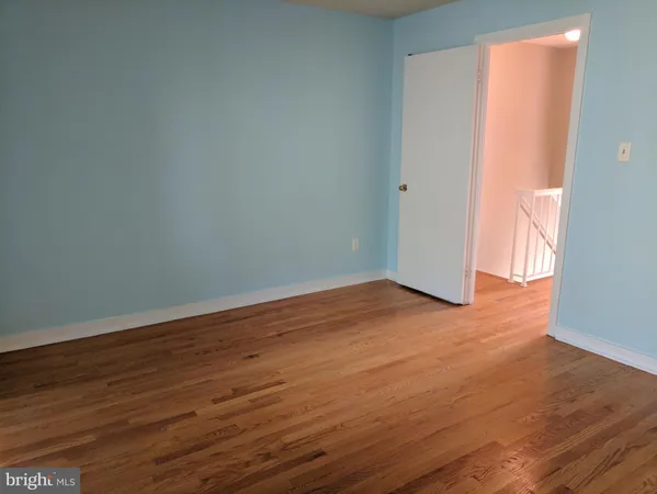 an empty room with wooden floor