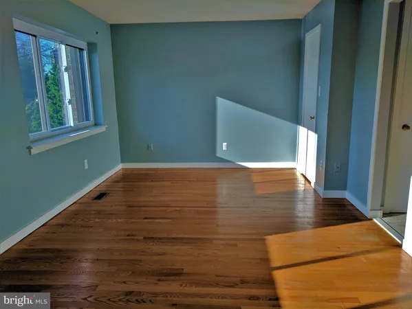 a view of wooden floor and windows in a room