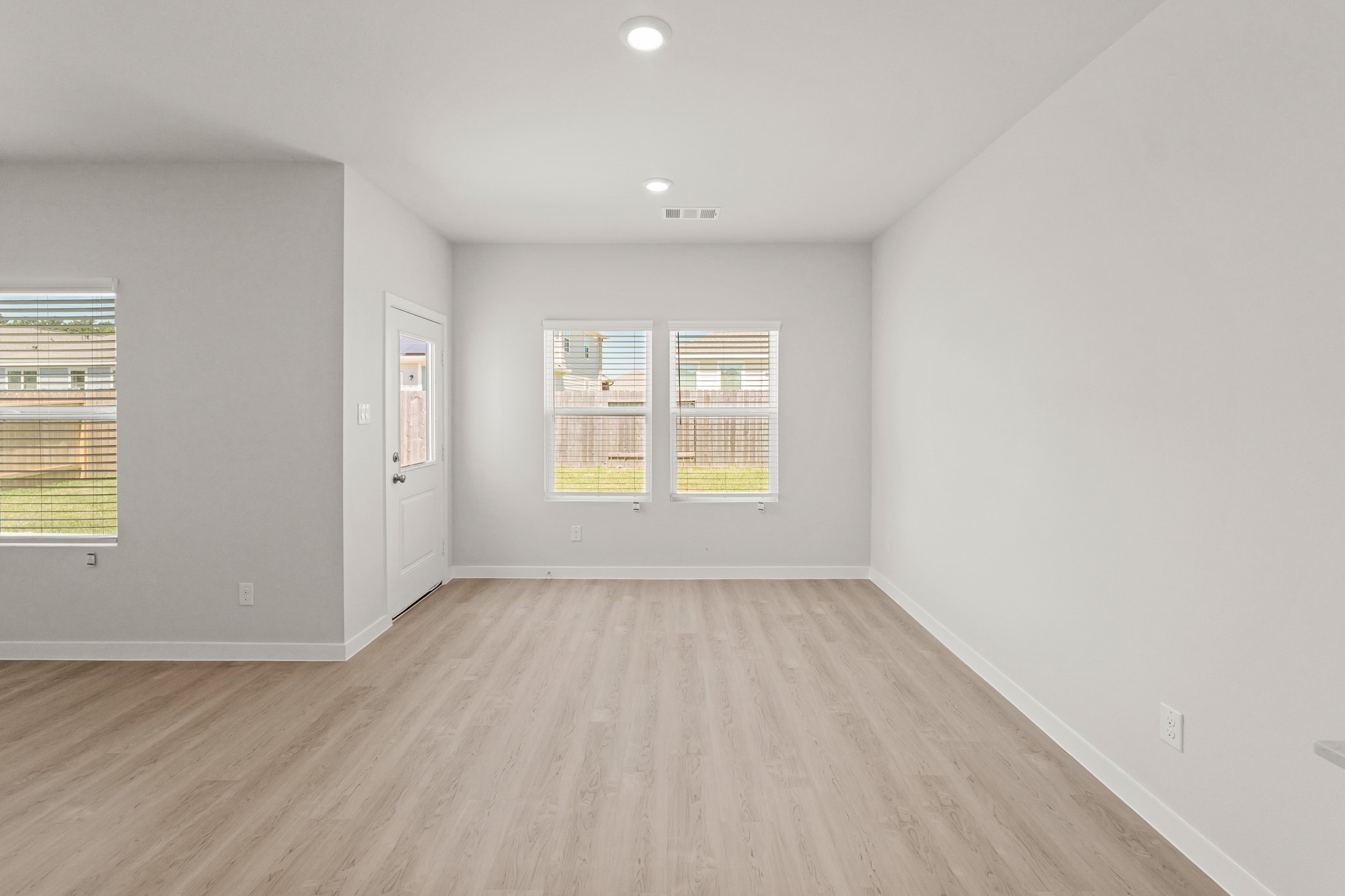 9782 Caney Bend Road Conroe, TX 77303 - Photo 12 of 32 an empty room with wooden floor and windows