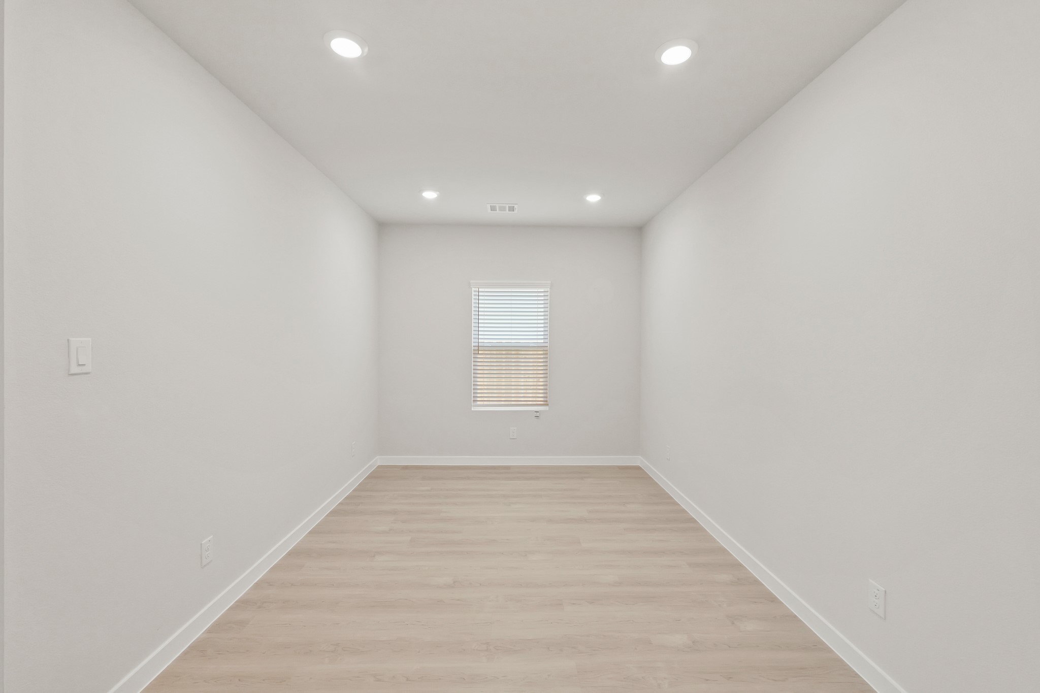 9782 Caney Bend Road Conroe, TX 77303 - Photo 14 of 32 an empty room with wooden floor and windows