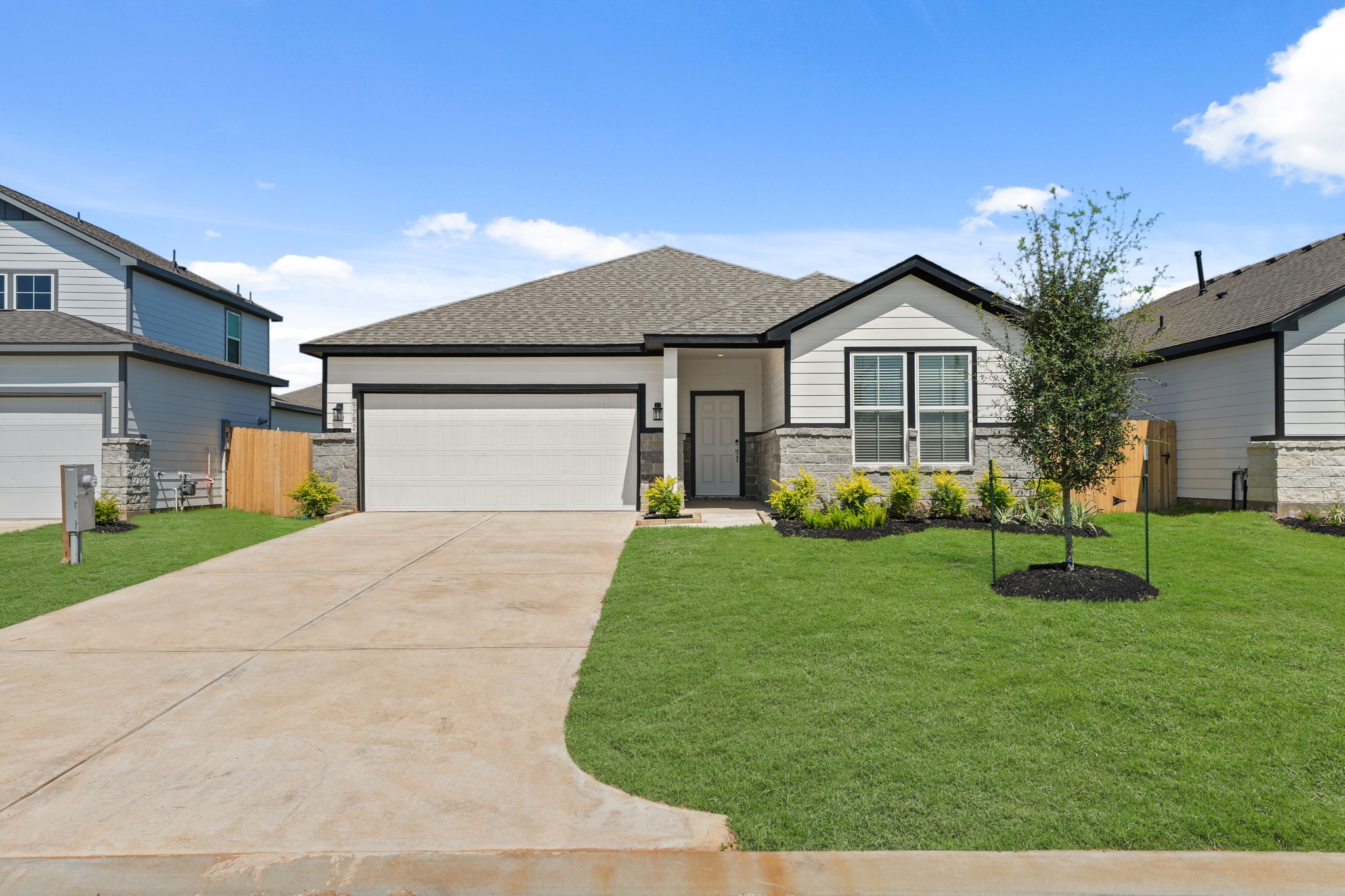 9782 Caney Bend Road Conroe, TX 77303 - Photo 2 of 32 a front view of a house with a yard and garage