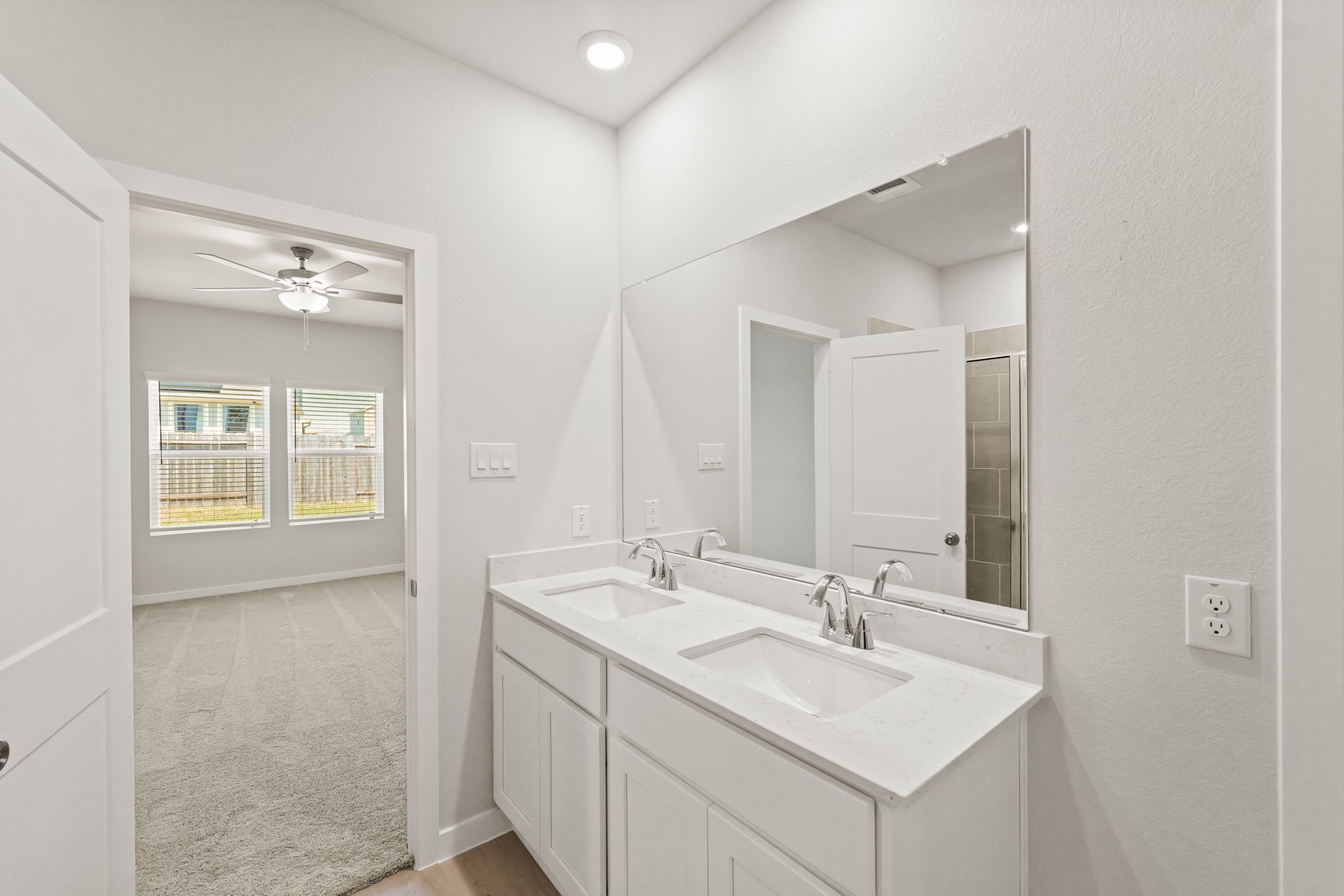 9782 Caney Bend Road Conroe, TX 77303 - Photo 25 of 32 a bathroom with 2 sink and a mirror