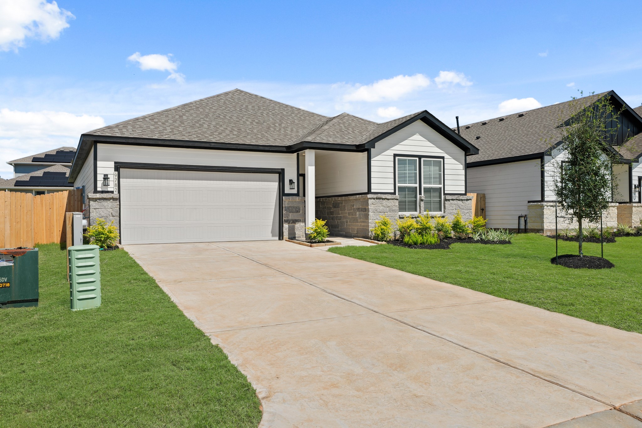 9782 Caney Bend Road Conroe, TX 77303 - Photo 3 of 32 a front view of a house with a yard and garage