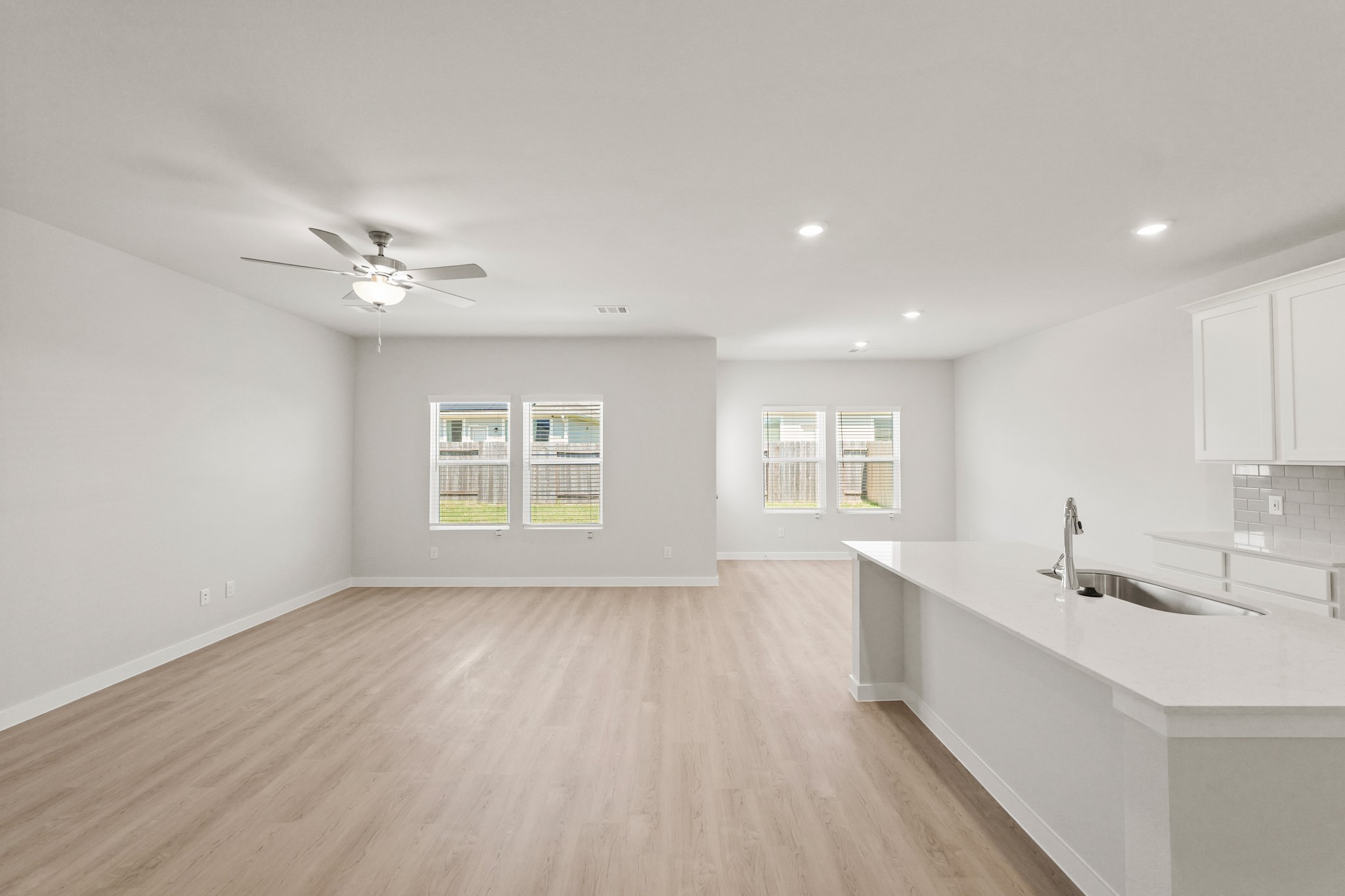 9782 Caney Bend Road Conroe, TX 77303 - Photo 7 of 32 a view of a kitchen with a sink and dishwasher with wooden floor