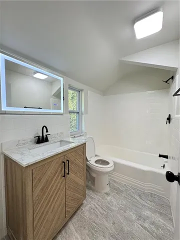a bathroom with a sink a toilet and a tub