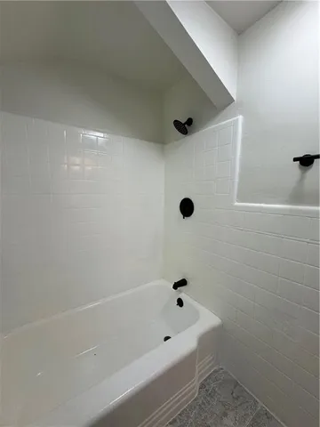a bathroom with a bathtub and shower