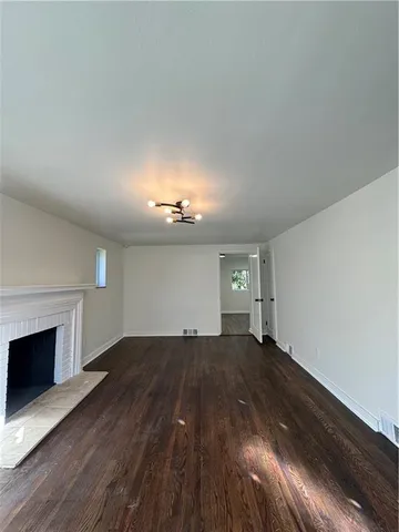 a view of a room with wooden floor and fireplace