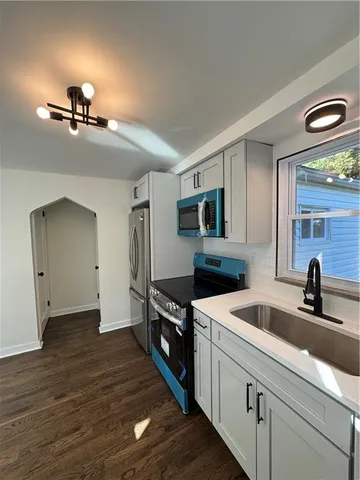 a kitchen with a sink and refrigerator