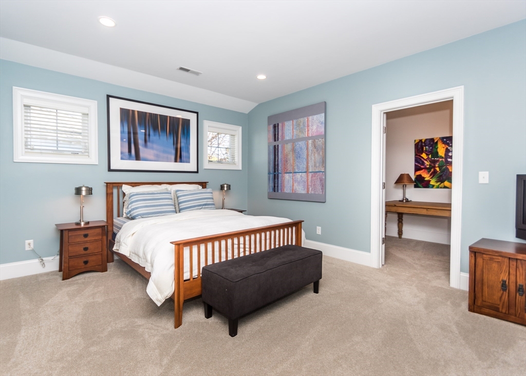 128 Church Street, Unit 2 Waltham, MA 02452 - Photo 22 of 41 a spacious bedroom with a bed and a cabinets